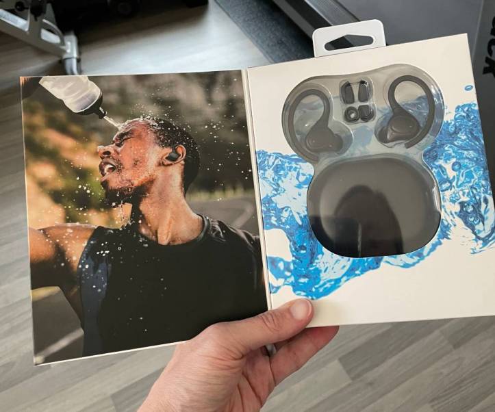 iLive earbuds packaging insert, showing a photo of a guy squirting his water bottle all over his face. 